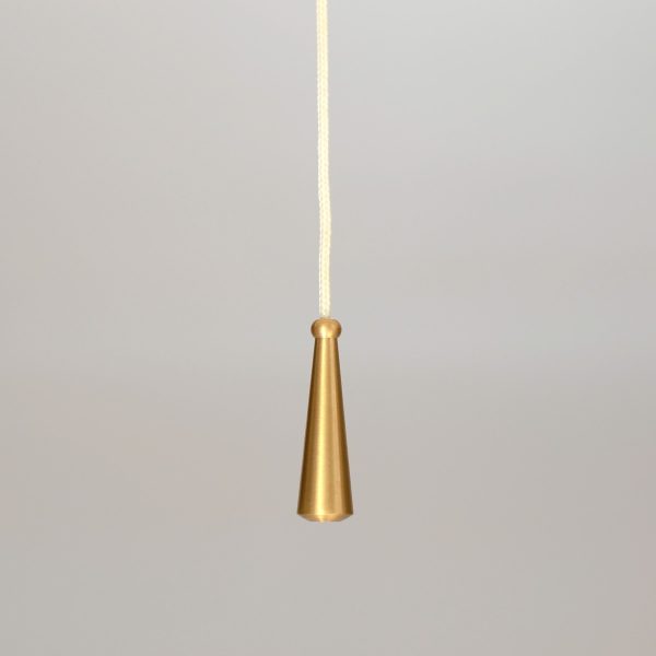 solid brass cord pull handle with conical shape shown on white cord.