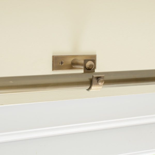 solid brass curtain centre bracket shown with curtain pole