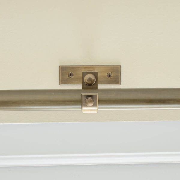 solid brass curtain centre bracket shown with curtain pole