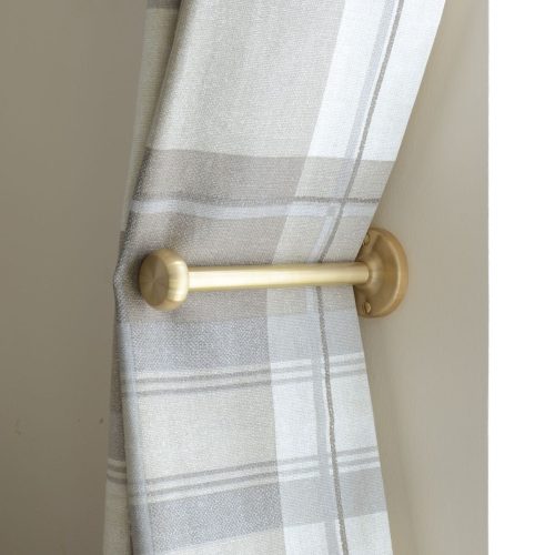 solid brass curtain holdback with button shaped end, shown in use.