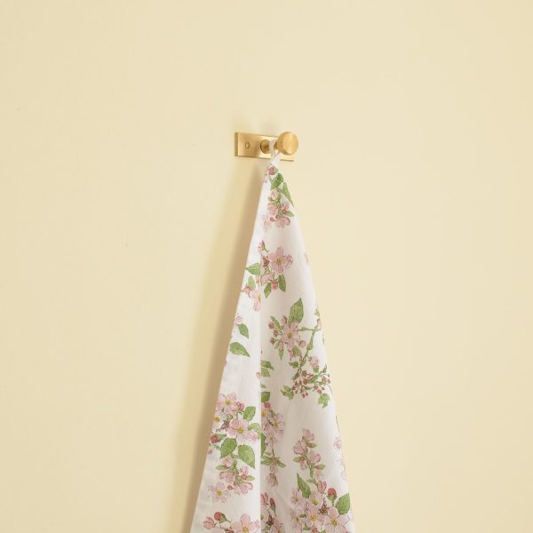 solid brass single wall hanger hook with a towel hanging from it