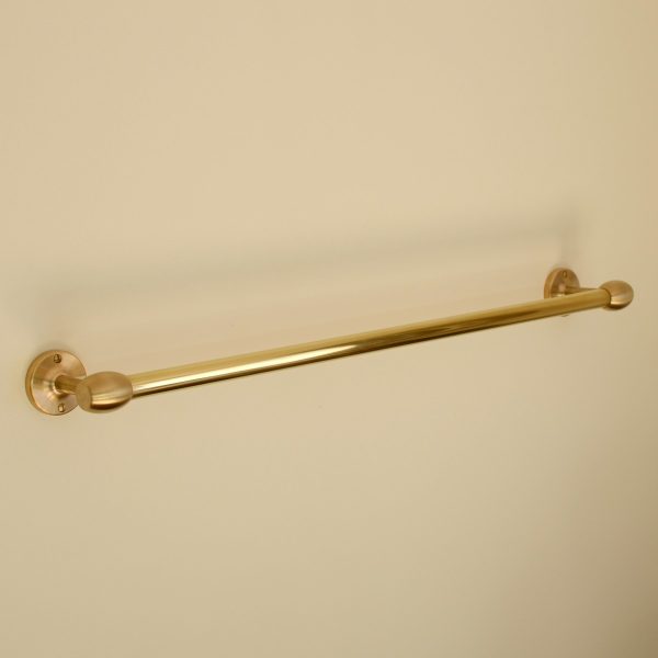 solid brass towel rail mounted to wall