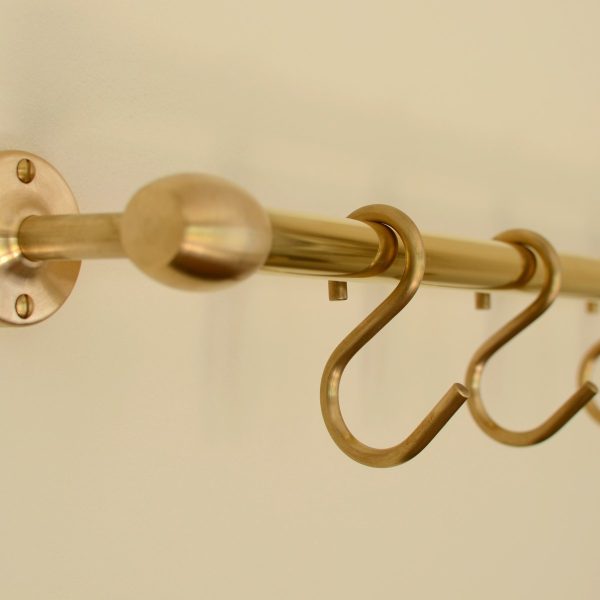 solid brass utility rail mounted to wall