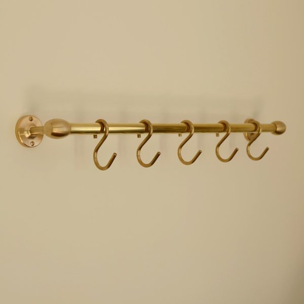 solid brass utility rail mounted to wall